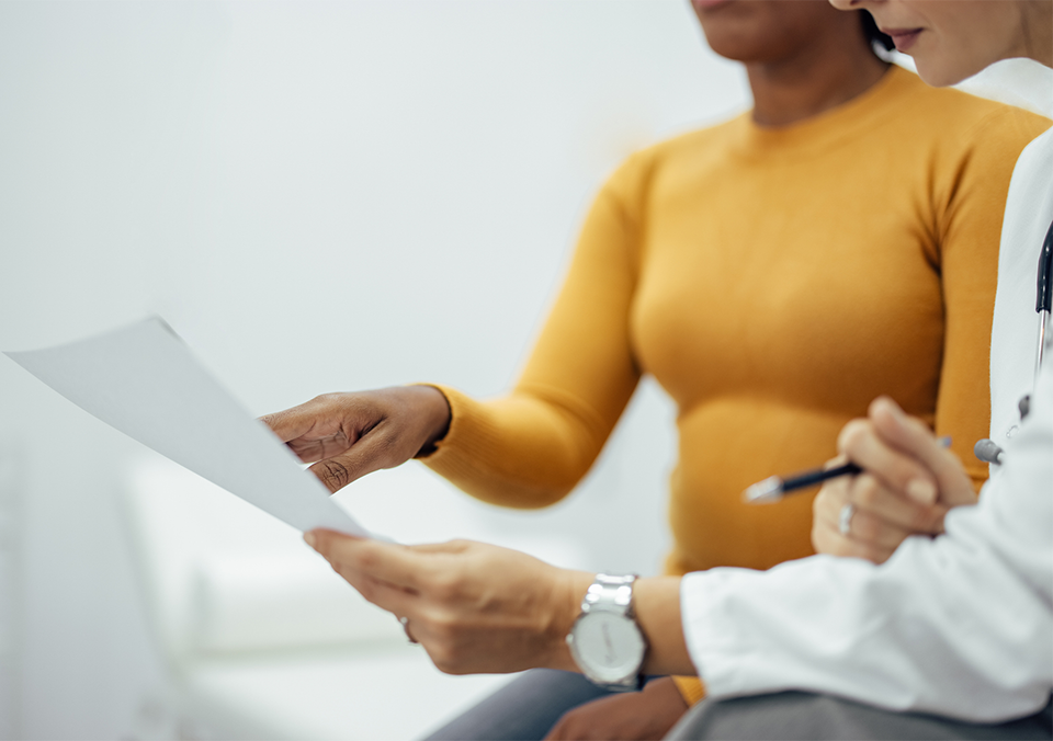 doctor going over test results with a patient who is concerned about mitochondria and aging.